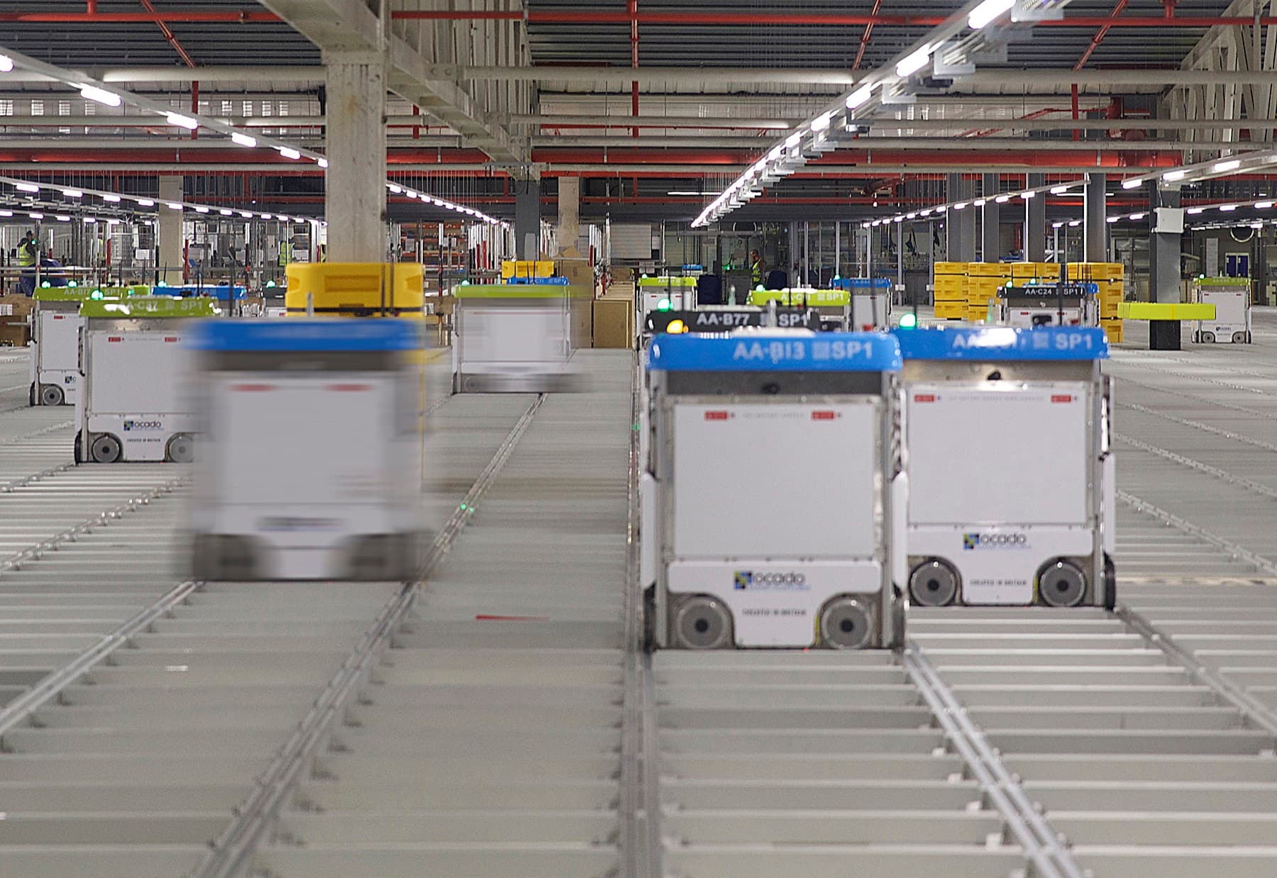 Warehouse robots moving across an automated storage grid